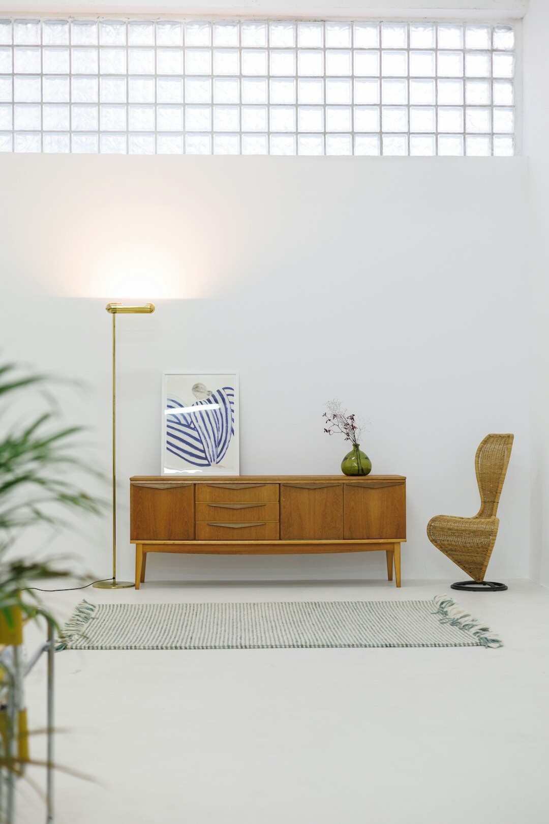 Curated vintage furniture display with a retro lounge chair and ceramic lamp