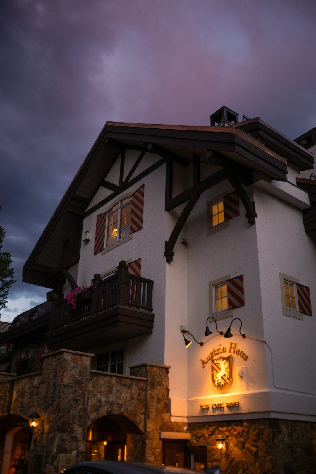 Traditional alpine ski chalet exterior glowing at dusk